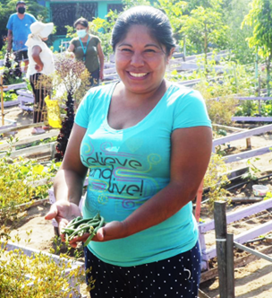Photo: Jessica Lucanas, member of the Mujeres Unidas por la Seguridad  Alimentaria y Ambiental (MUSA) project shown here in the community garden.